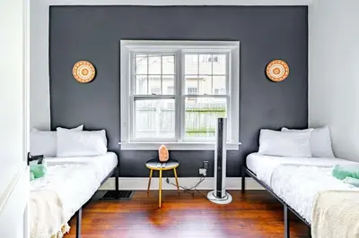 two beds in a room with a window at Yoctangee House by Jungle House in Chillicothe