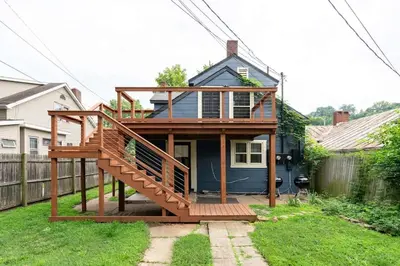 a house with a deck in a yard at Yoctangee House by Jungle House in Chillicothe