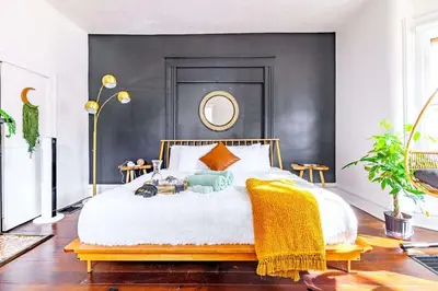 a bedroom with a bed with a black wall at Yoctangee House by Jungle House in Chillicothe