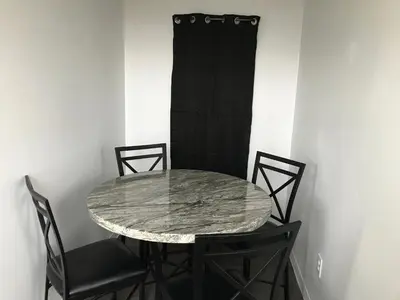 a marble table and chairs in a room at Castle Apartments in Marion