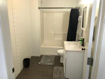 a bathroom with a tub and a toilet and a sink at Castle Apartments in Marion