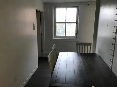 an empty room with a wooden table and a window at Castle Apartments in Marion
