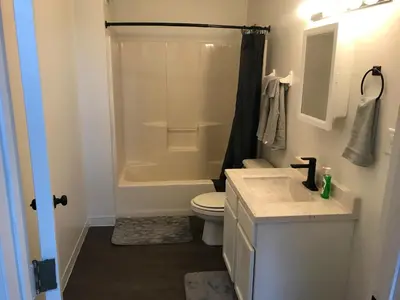 a bathroom with a toilet and a sink and a shower at Castle Apartments in Marion