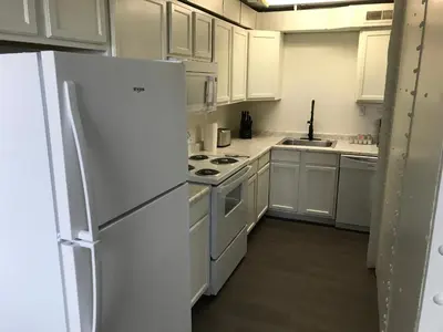 a kitchen with white cabinets and a white refrigerator at Castle Apartments in Marion