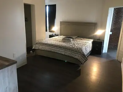 a bedroom with a bed and two night stands and a window at Castle Apartments in Marion