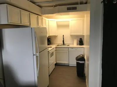 a kitchen with white cabinets and a refrigerator at Castle Apartments in Marion