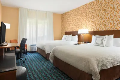 a hotel room with two beds and a television at Fairfield Inn & Suites by Marriott Athens in Athens