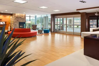 an office lobby with a couch and a fireplace at Fairfield Inn & Suites by Marriott Athens in Athens