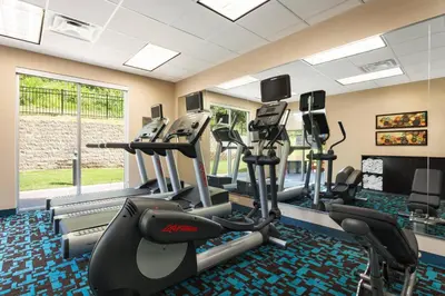 a fitness room with treadmills and elliptical machines at Fairfield Inn & Suites by Marriott Athens in Athens