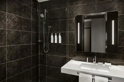 a bathroom with a sink and a shower at AC Hotel Cincinnati at Liberty Center in West Chester