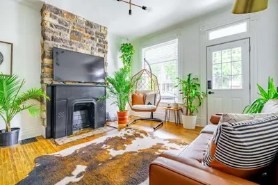 a living room with a couch and a fireplace at Jungle Fever by Jungle House Walk to High Street Near Convention Center OSU & Nationwide Arena Downtown & Short North 5 800 Reviews Private Parking in Columbus
