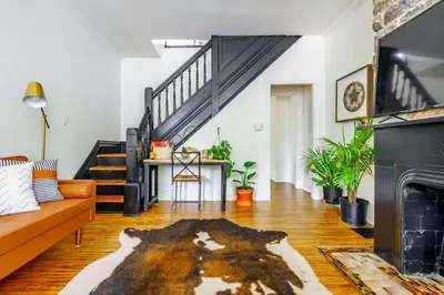 a living room with a couch and a fireplace at Jungle Fever by Jungle House Walk to High Street Near Convention Center OSU & Nationwide Arena Downtown & Short North 5 800 Reviews Private Parking in Columbus