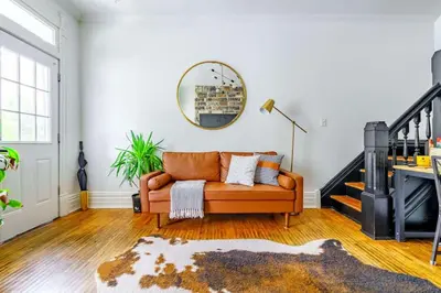a living room with a couch and a mirror at Jungle Fever by Jungle House Walk to High Street Near Convention Center OSU & Nationwide Arena Downtown & Short North 5 800 Reviews Private Parking in Columbus