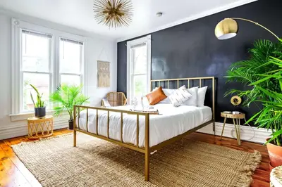 a bedroom with a bed with a black wall at Jungle Fever by Jungle House Walk to High Street Near Convention Center OSU & Nationwide Arena Downtown & Short North 5 800 Reviews Private Parking in Columbus
