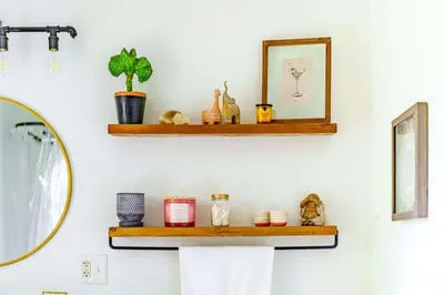 a shelf on a bathroom wall with a mirror at Jungle Fever by Jungle House Walk to High Street Near Convention Center OSU & Nationwide Arena Downtown & Short North 5 800 Reviews Private Parking in Columbus