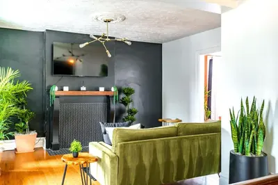 a living room with a couch and a fireplace at Bamboo Bungalow by Jungle House Near Convention Center OSU & Nationwide Arena Walk to High Street Downtown & Short North 5 800 Reviews Private Parking in Columbus