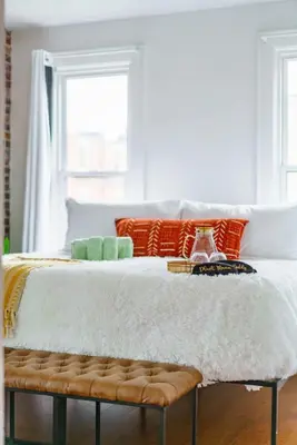 a white bed with a bench in a room at Bamboo Bungalow by Jungle House Near Convention Center OSU & Nationwide Arena Walk to High Street Downtown & Short North 5 800 Reviews Private Parking in Columbus
