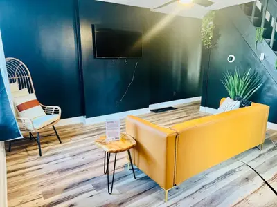 an office with a yellow couch and two chairs at Cozy Casita by Jungle House Downtown & Short North Free Parking 5 800 Reviews Near Convention Center & Nationwide Arena & Ohio State Walk to High Street in Columbus