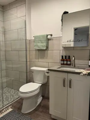 a bathroom with a toilet and a shower and a sink at Jungle Vibe by Jungle House Downtown & Short North Free Parking 5 800 Reviews Near Convention Center & Nationwide Arena & Ohio State Walk to High Street in Columbus