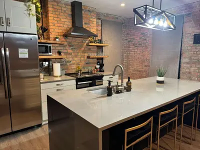 a kitchen with a sink and a refrigerator at Jungle Vibe by Jungle House Downtown & Short North Free Parking 5 800 Reviews Near Convention Center & Nationwide Arena & Ohio State Walk to High Street in Columbus