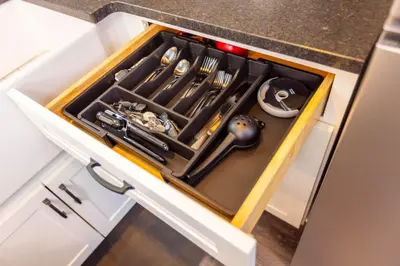 a drawer in a cabinet filled with utensils at Black Tie Affair - Eloquent Riverfront Experience in New Richmond