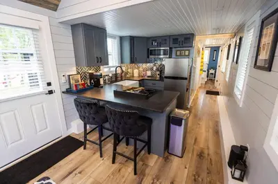 a kitchen with a counter and a stove and a refrigerator at Hagrid's Hut - Harry Potter Riverfront Experience in New Richmond