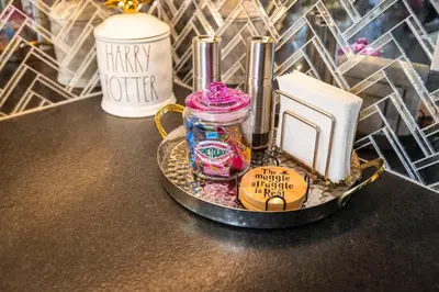a tray with a jar and a book on a counter at Hagrid's Hut - Harry Potter Riverfront Experience in New Richmond