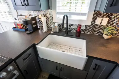 a kitchen counter with a sink in a kitchen at Hagrid's Hut - Harry Potter Riverfront Experience in New Richmond