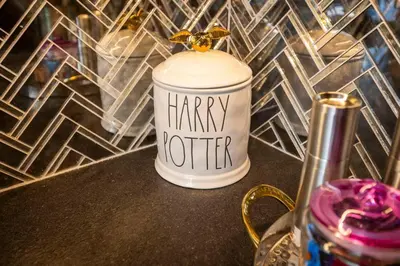 a jar with the words happy hotter sitting on a table at Hagrid's Hut - Harry Potter Riverfront Experience in New Richmond