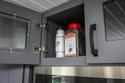 a bottle of seasoning sitting on top of a microwave at Hagrid's Hut - Harry Potter Riverfront Experience in New Richmond