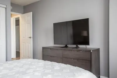 a bedroom with a flat screen tv on a dresser at Landing Stunning Studio Game Room Pool in Fort Wayne