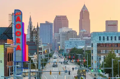 a city street with a neon sign and a hotel sign at Landing Amazing 2BD Gym Courtyard in Cleveland