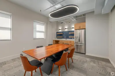 a large kitchen with a wooden table and chairs at Landing Amazing 2BD Gym Courtyard in Cleveland