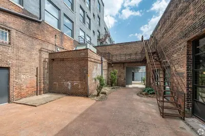 a brick building with a staircase next to it at Landing Amazing 2BD Gym Courtyard in Cleveland
