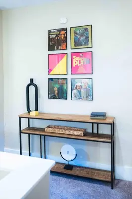 a table with a keyboard on a wall with pictures at Bright and Hip 2BR Condo in Heart of Ohio City in Cleveland