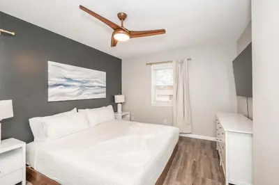 a bedroom with a bed and a ceiling fan at The Terrace Timber House For 8 in Hamilton