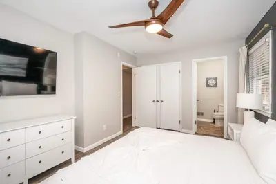 a bedroom with a bed and a ceiling fan at The Terrace Timber House For 8 in Hamilton