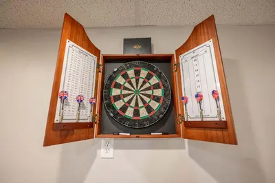 a dart board in a wall with two windows at The Terrace Timber House For 8 in Hamilton