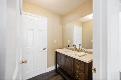 a bathroom with a sink and a mirror at Nookside Grand Estate For 8 in Hamilton