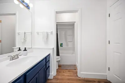 a white bathroom with a sink and a toilet at Nookside Grand Estate For 8 in Hamilton