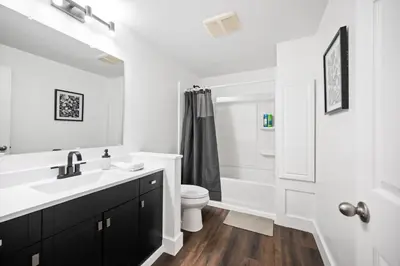 a white bathroom with a sink and a toilet at Nookside Grand Estate For 8 in Hamilton