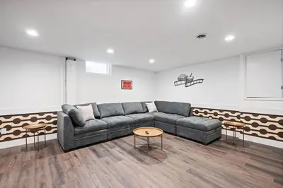 a living room with a couch and a table at Nookside Grand Estate For 8 in Hamilton