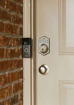 a door with a speaker on a brick wall at 