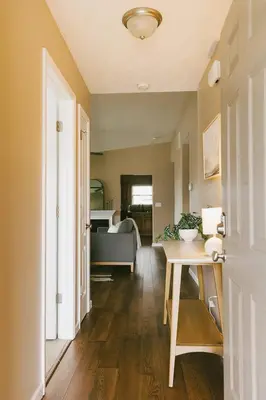a hallway with a table and a living room at 