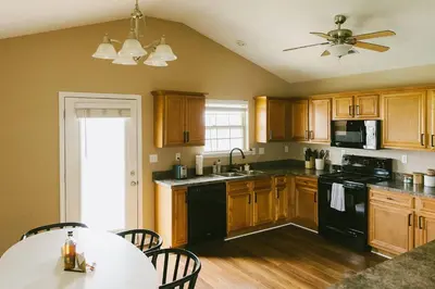 a kitchen with wooden cabinets and a black appliances at 