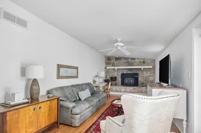 a living room with a couch and a fireplace at Charming Cottage | Near I-75 & Horse Park + Farms in Lexington