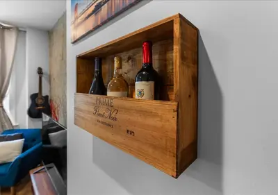 a wooden box with bottles of wine on a wall at OTR - Court Street Entertainment District Cincinnati in Cincinnati