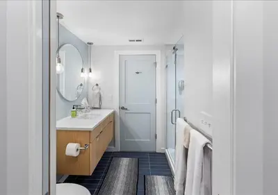 a bathroom with a sink and a toilet and a mirror at OTR - Court Street Entertainment District Cincinnati in Cincinnati
