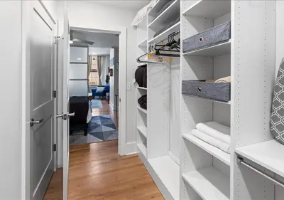 a walk in closet with white shelves at OTR - Court Street Entertainment District Cincinnati in Cincinnati
