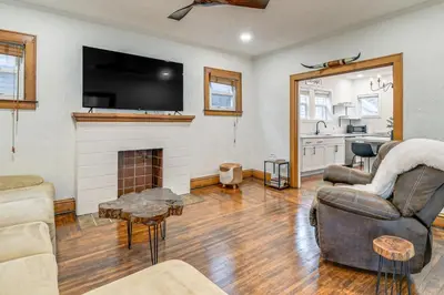 a living room with a fireplace and a tv at Walk to Marshall University Home with Private Yard! in Huntington